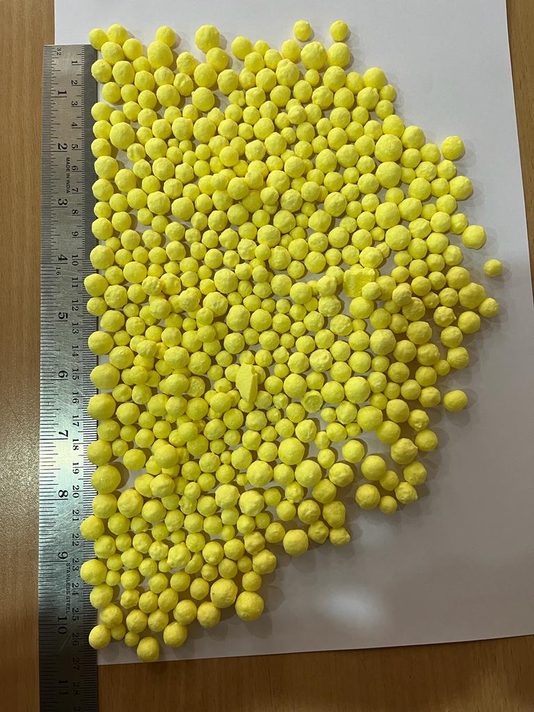 Close-up of uniform bright yellow sulphur granules
